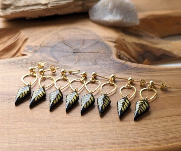 Gold leaf - diamond drop earrings. Delicate and classy elongated diamond shape black clay drops with gold leaf pattern and gold coloured teardrop connector.