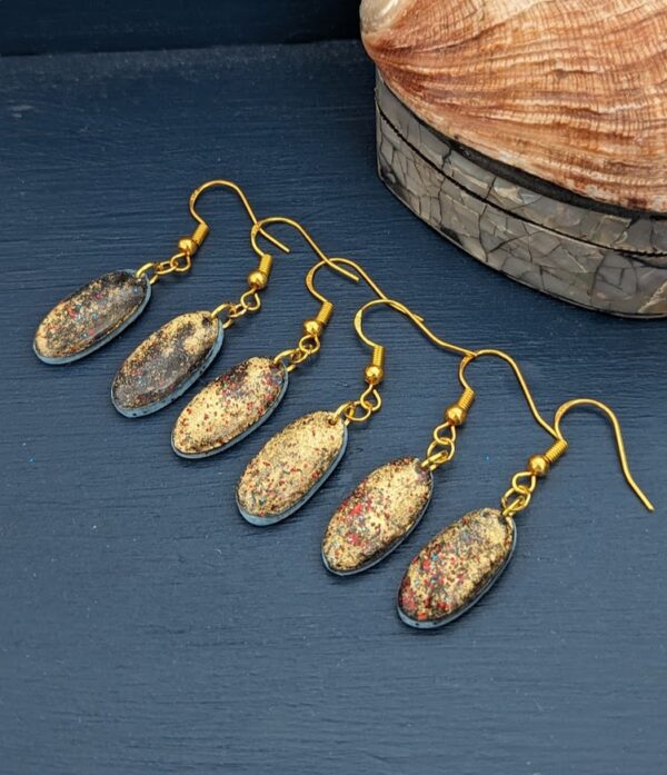 The Black Opals Collection - Stunning opal effect simple dangly earrings, black with gold and hints of red and blue. Oval shape